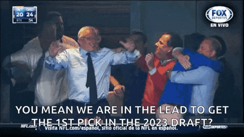 a group of men are hugging in front of a screen that says fox