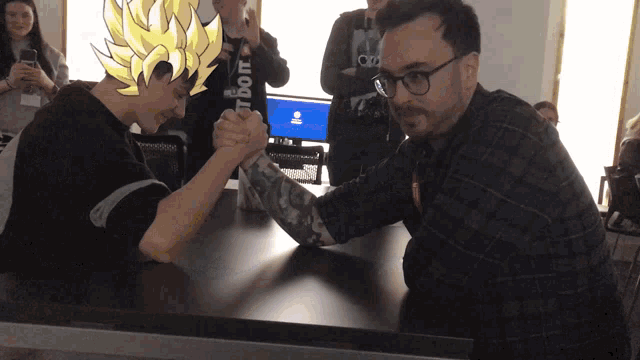 two men arm wrestling with one wearing a shirt that says " just do it " on it