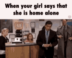 when your girl says that she is home alone , a man in a suit is standing in front of a counter .