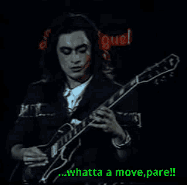 a man is playing a guitar in front of a sign that says ' miguel '