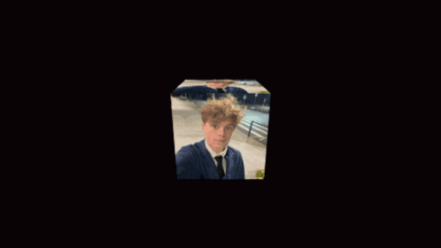 a blurry picture of a man in a suit and tie holding something