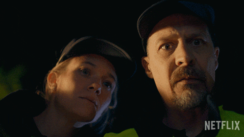 a man and a woman looking at each other with a netflix logo behind them
