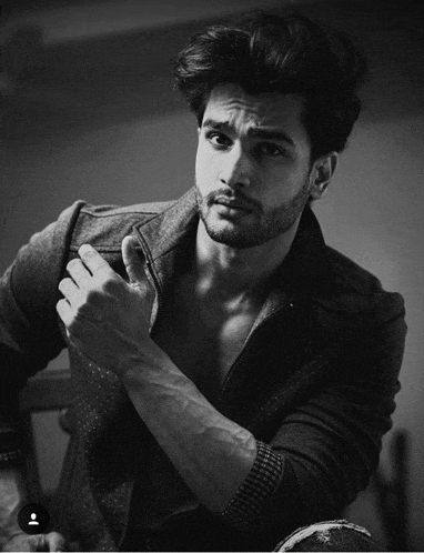 a black and white photo of a shirtless man