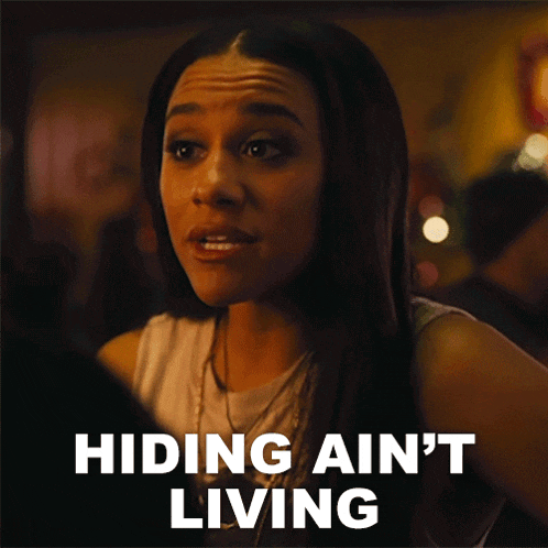 a woman says hiding ain 't living next to a picture of her