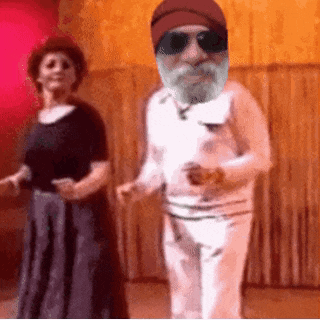 a man with a beard and hat is dancing with a woman