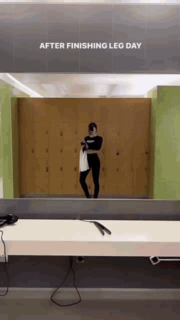 a woman is taking a picture of herself in a gym mirror with the words after finishing leg day above her