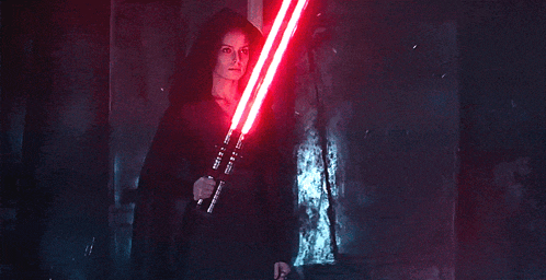 a person holding two red lightsabers in their hands