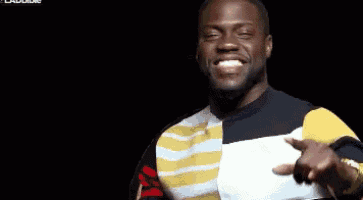 a man in a striped sweater is making a funny face while holding a piece of paper in his hand .