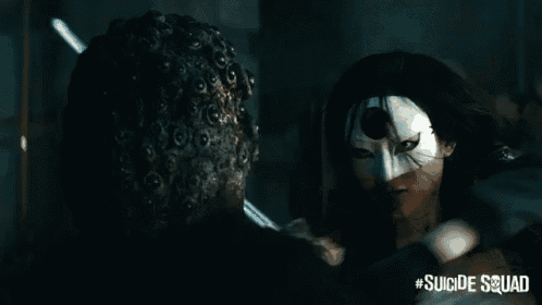 a poster for the suicide squad shows a woman in a white mask