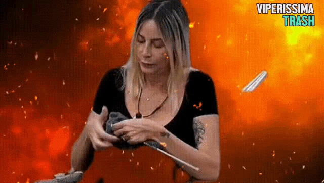 a woman is holding a feather in front of a fire background with the words viperissima trash