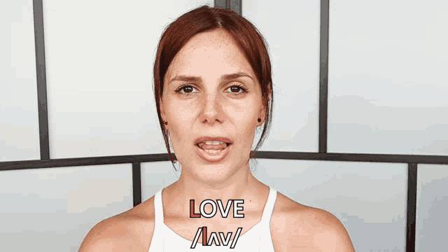 a woman with red hair has the word love on her neck
