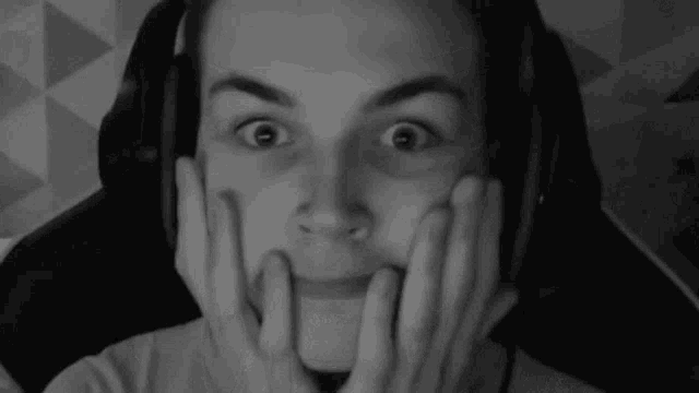 a man wearing headphones is making a funny face .