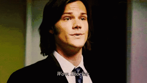 a man in a suit and tie is talking and says wow shocker .