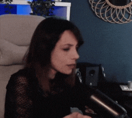 a woman sitting in a chair with a microphone