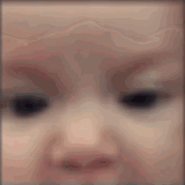 a blurry picture of a baby 's face with a red lip