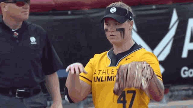 a woman wearing a yellow jersey that says athletic unlimited