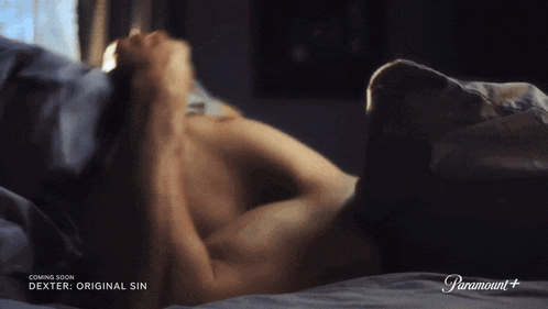 a man laying on a bed with the words coming soon dexter original sin above him