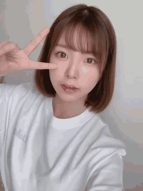 a girl wearing a white t-shirt that says hello on it