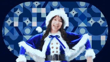a woman in a santa costume is smiling in front of a patterned background