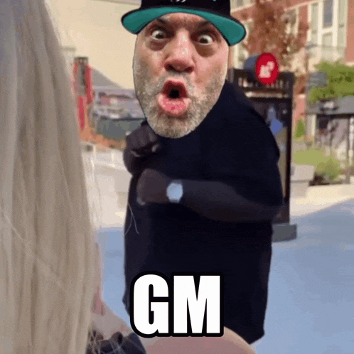 a man with a beard wearing a hat says gm in white letters