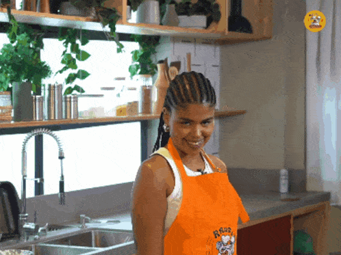 a woman in a kitchen wearing an apron that says ross on it