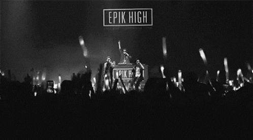 a black and white photo of a crowd of people at a epic high concert .