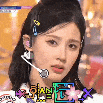 a close up of a woman wearing a headset with the words comeback on the screen behind her