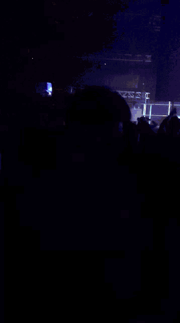a man with face paint on his face is standing in a crowd of people