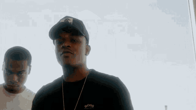a man wearing a black shirt that says boss on the front