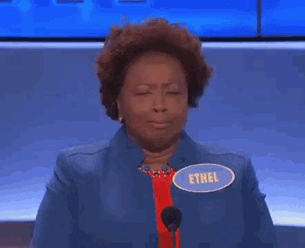 a woman wearing a name tag that says ethel
