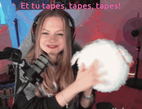 a woman holding a white ball with the words et tu tapes tapes tapes