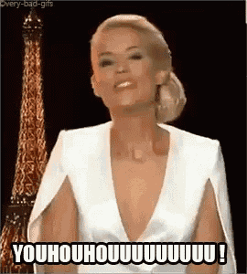a woman in a white dress is standing in front of an eiffel tower and making a funny face .