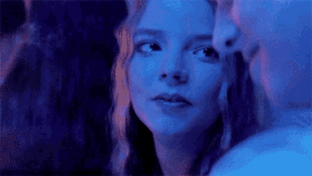 a close up of a woman 's face with a blue background