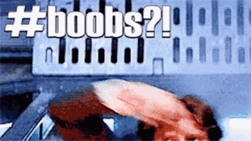 a man is sitting in a car with the word boobs written on the screen