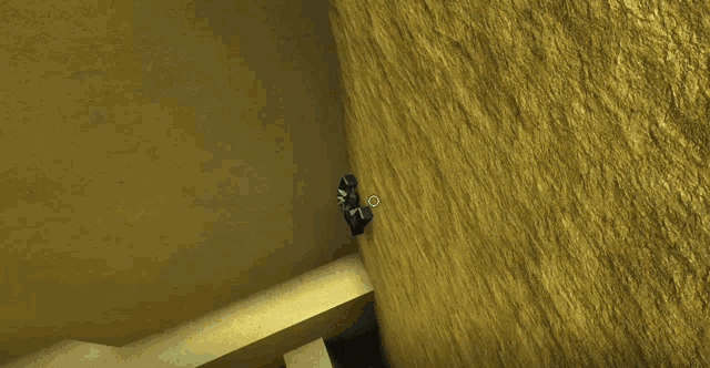a black object is against a wall with a white circle on it