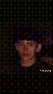 a man wearing a black hat and a black shirt is smiling in a pixelated photo .