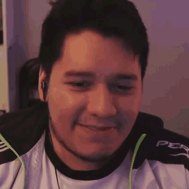a man wearing headphones and a jacket that says ps4 on the sleeve