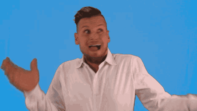 a man in a white shirt with his arms outstretched and his mouth open