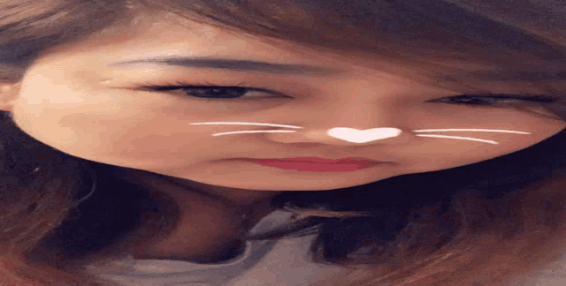 a woman with a heart on her nose