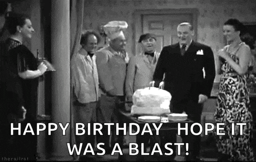 a group of people are standing around a table with a cake and the words `` happy birthday hope it was a blast ! ''