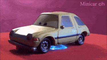 a toy car is sitting on a red surface with the words minicar ch written above it