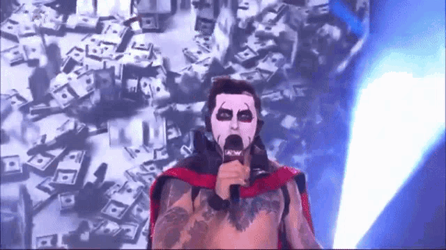 a wrestler is holding a microphone in front of a wall of money