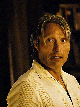 a man in a yellow shirt looks at the camera