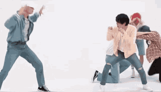a group of men are dancing together in a room .
