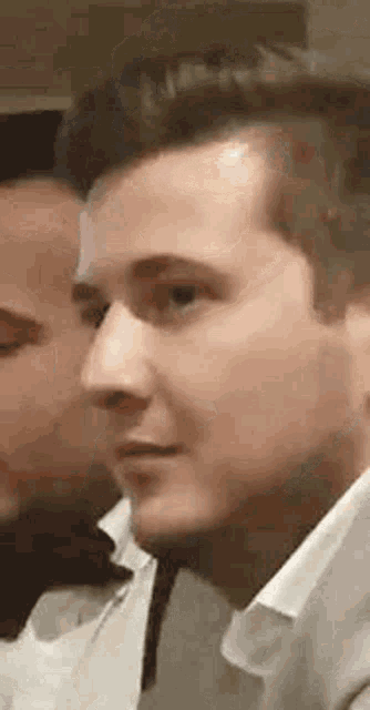 a close up of a man 's face with a blurred background .