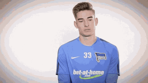 a soccer player wearing a blue shirt with the number 33 on it