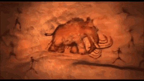 a painting of a mammoth in a cave with people .