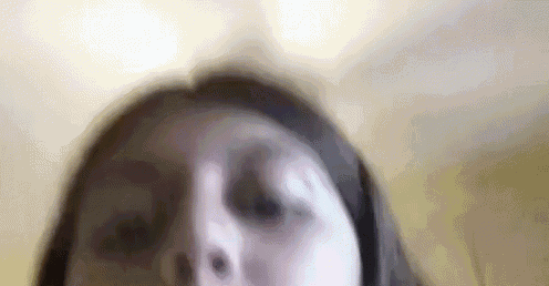 a close up of a woman 's face with a blurry background