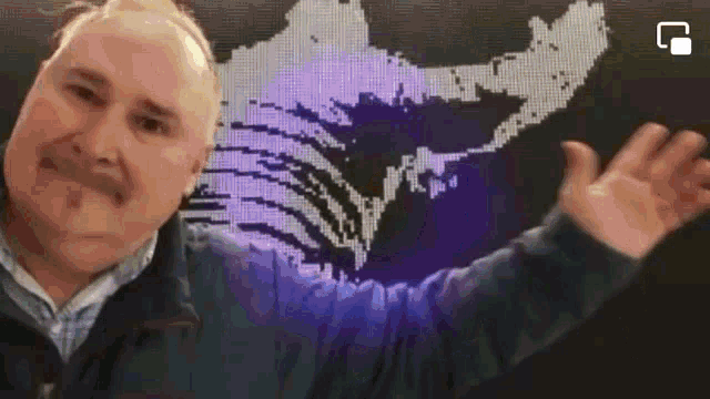 a man is standing in front of a purple map