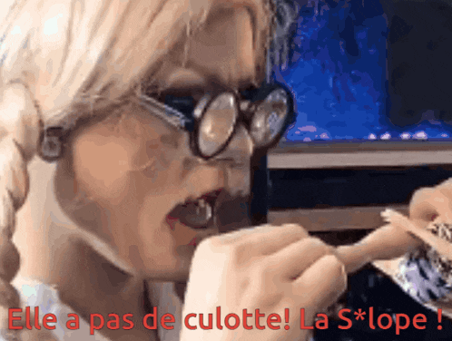 a woman wearing glasses is eating something with the words elle a pas de culotte la slope
